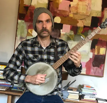 A photograph of Ty and his Banjo