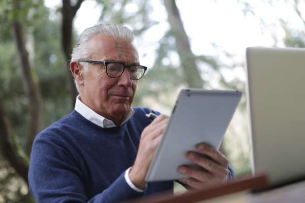 elderly man using tablet