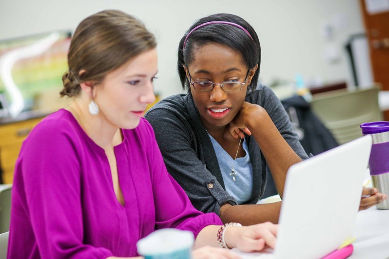 Two Baylor University students studying on a laptop