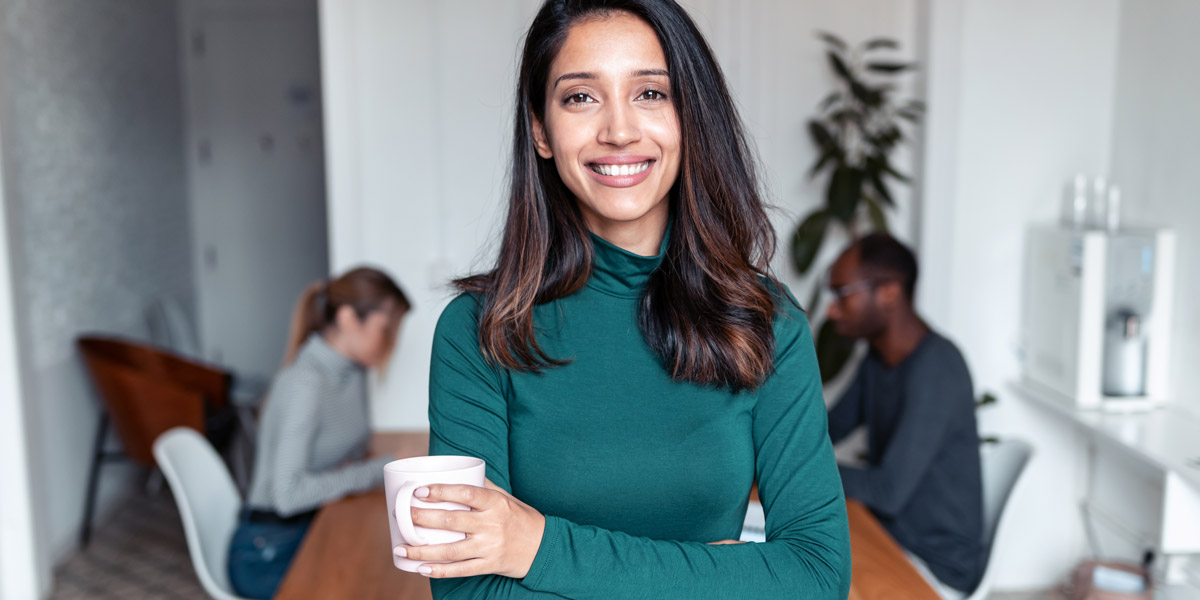 What is web scraping? A complete guide A data analyst standing holding a mug of tea, smiling at the camera