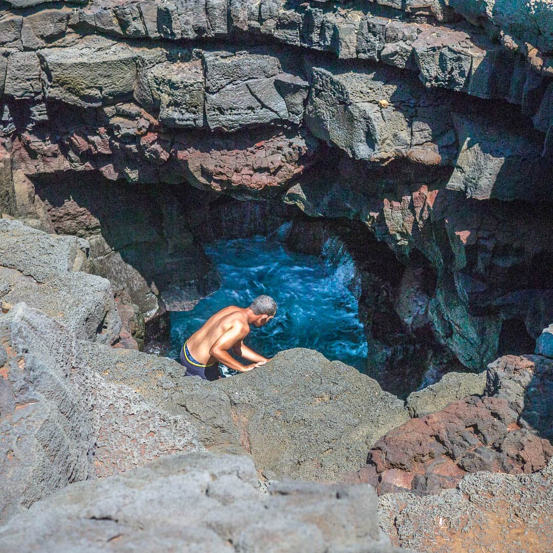 Man diving into a hole in the cliffs