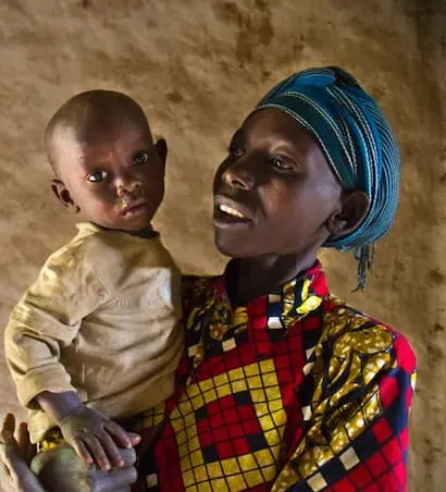 Mukankaka Seraphine with her youngest child at the family's home in southern Rwanda.