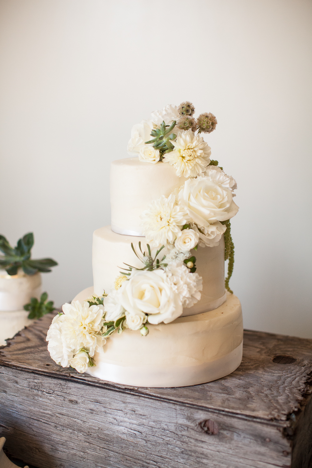 white wedding cake with floral elements