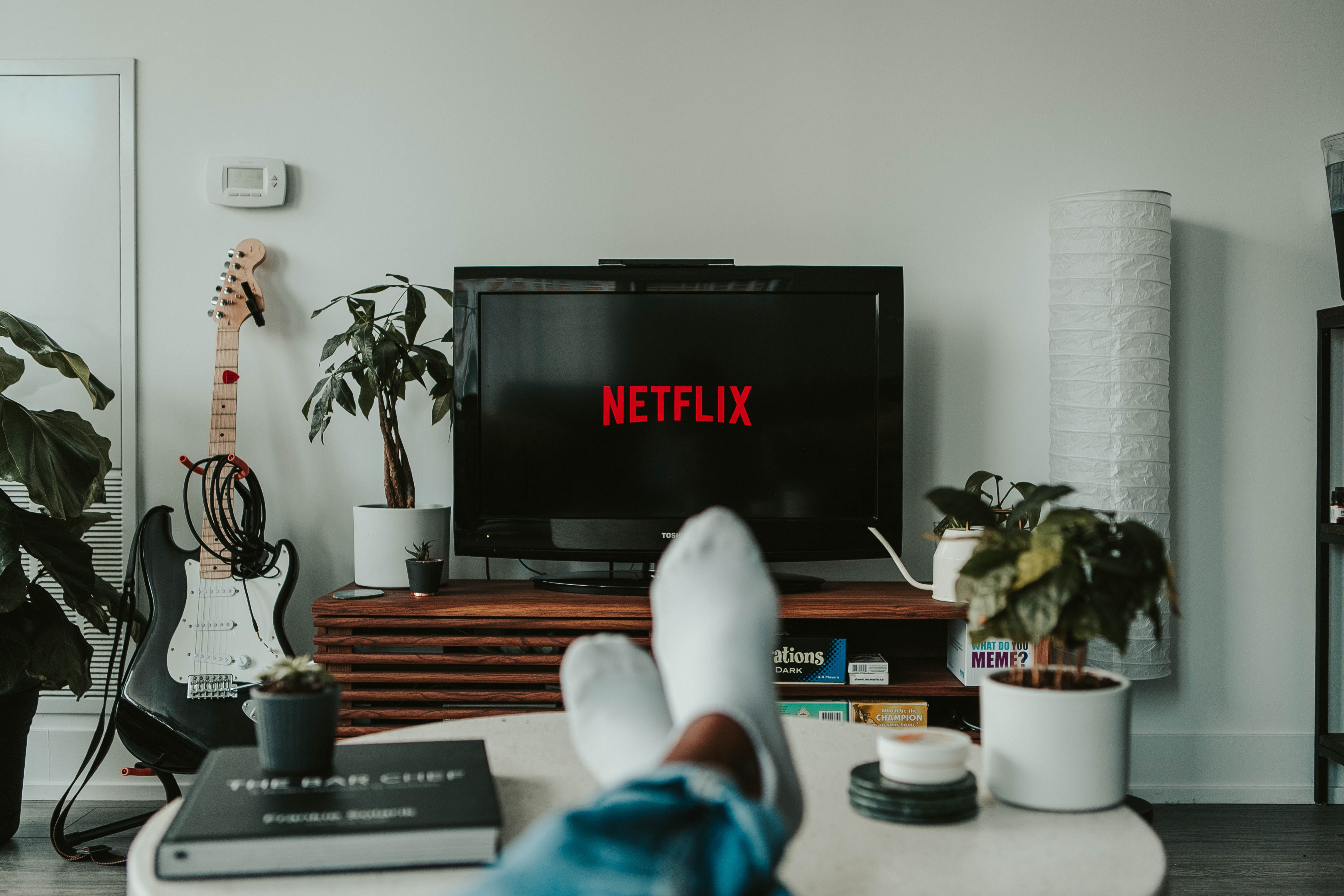feet on desk, watching Netflix on a television