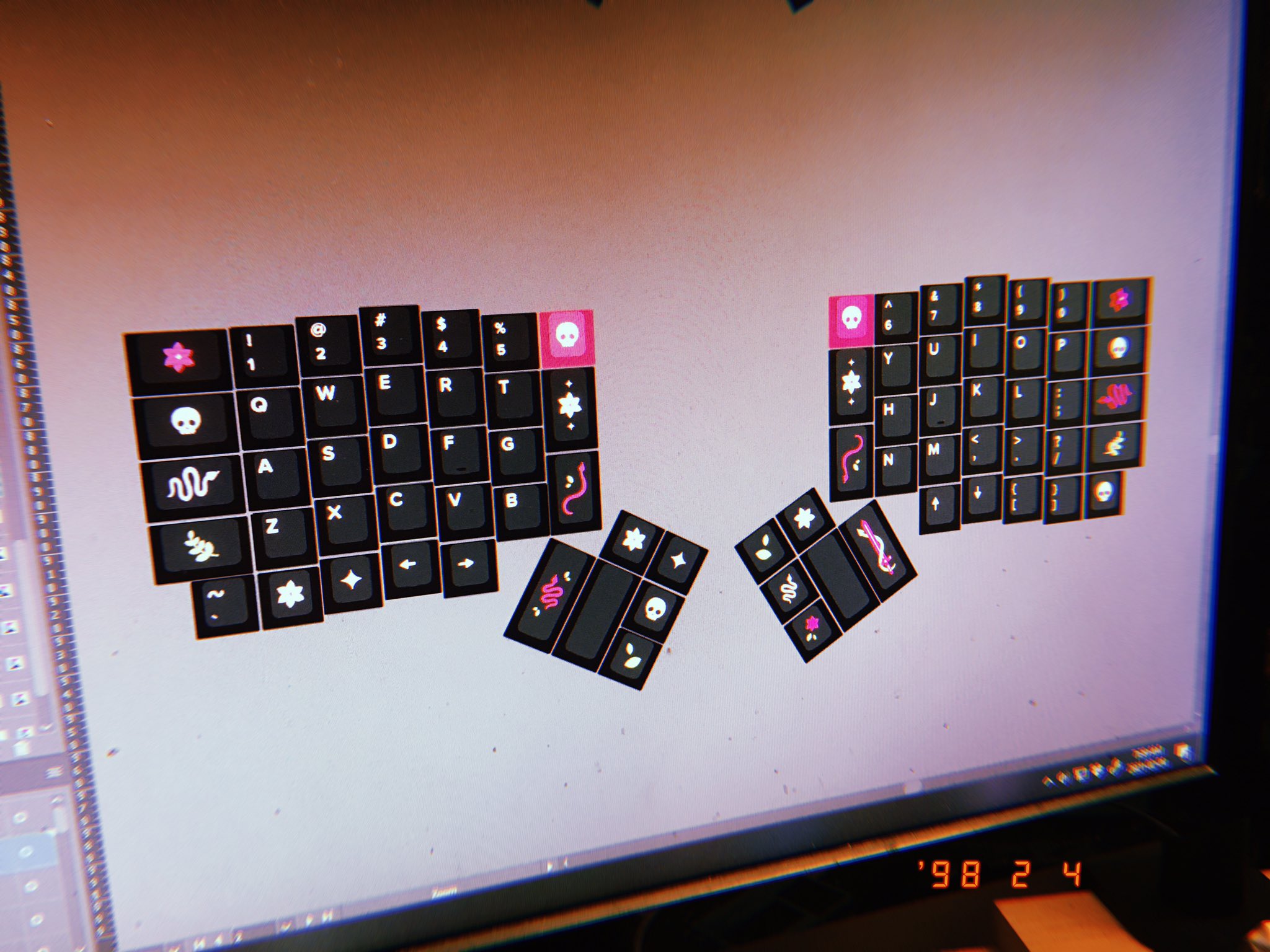 Black keycaps with floral and skull icons, arranged in an ergonomic layout.