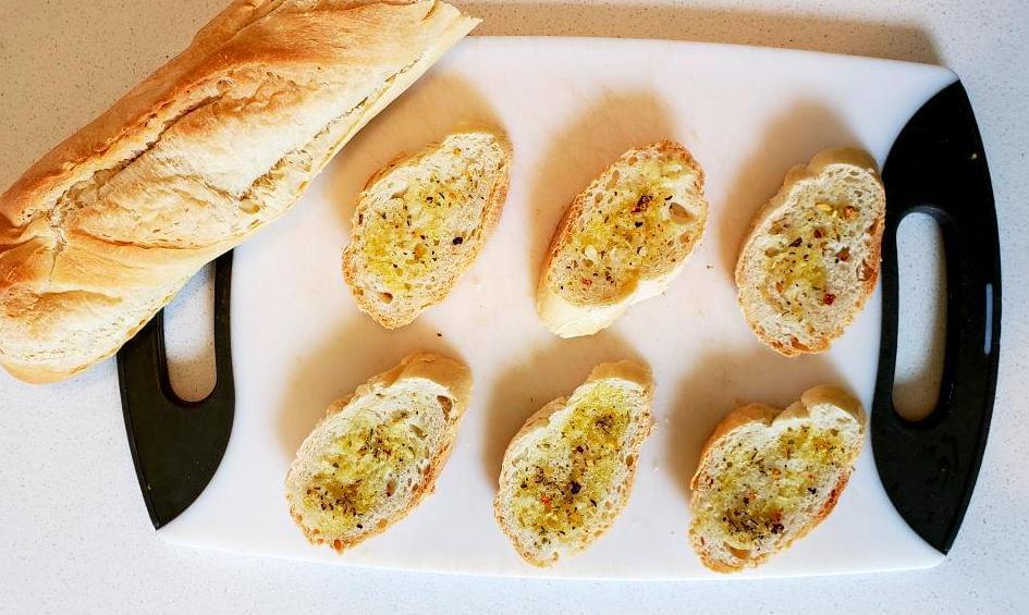 Baguette sliced and drizzled with garlic oil