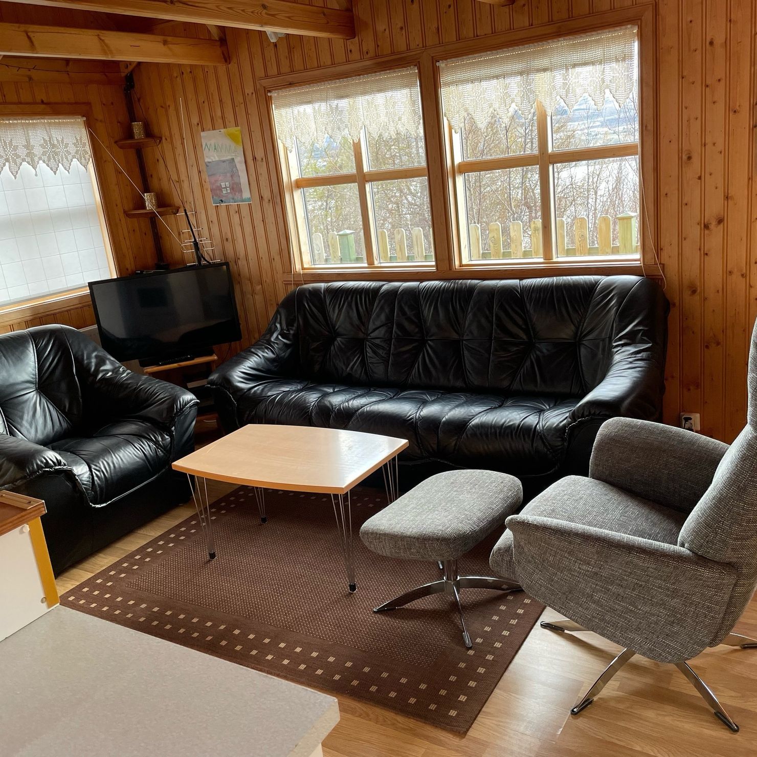 Comfortable armchairs and a large couch in the living area
