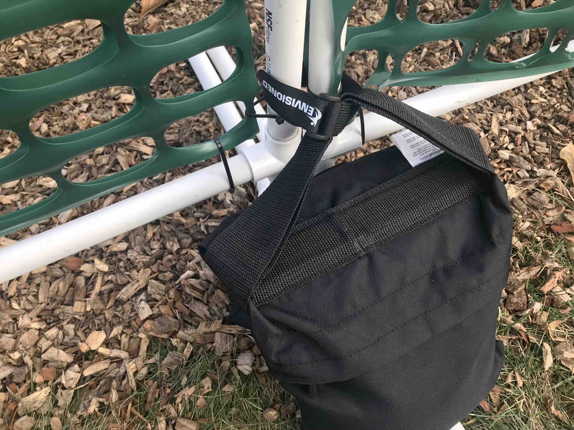 Velcro strap connecting gates and sandbag