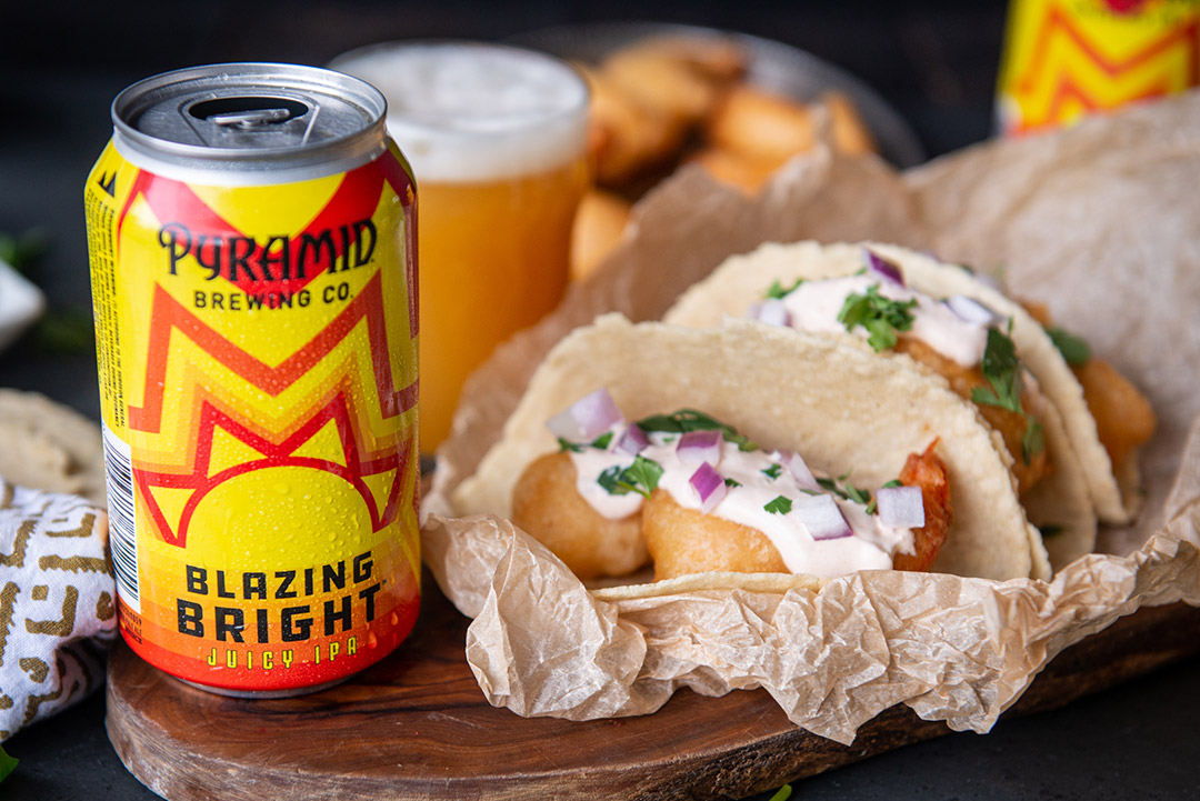 Tacos next to a Blazing Bright can on a wood board