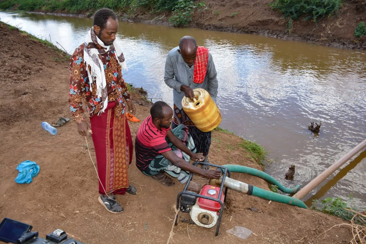 Men working on an irrigation pump