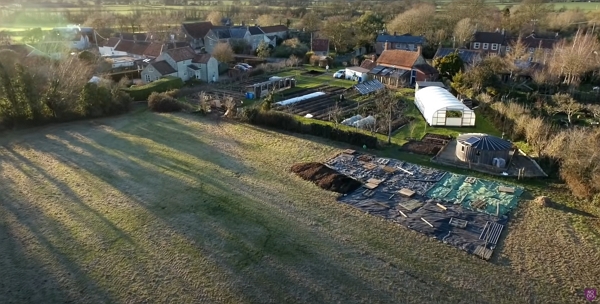 An aerial view of Homeacres property with an area covered with pallets and plastic sheets