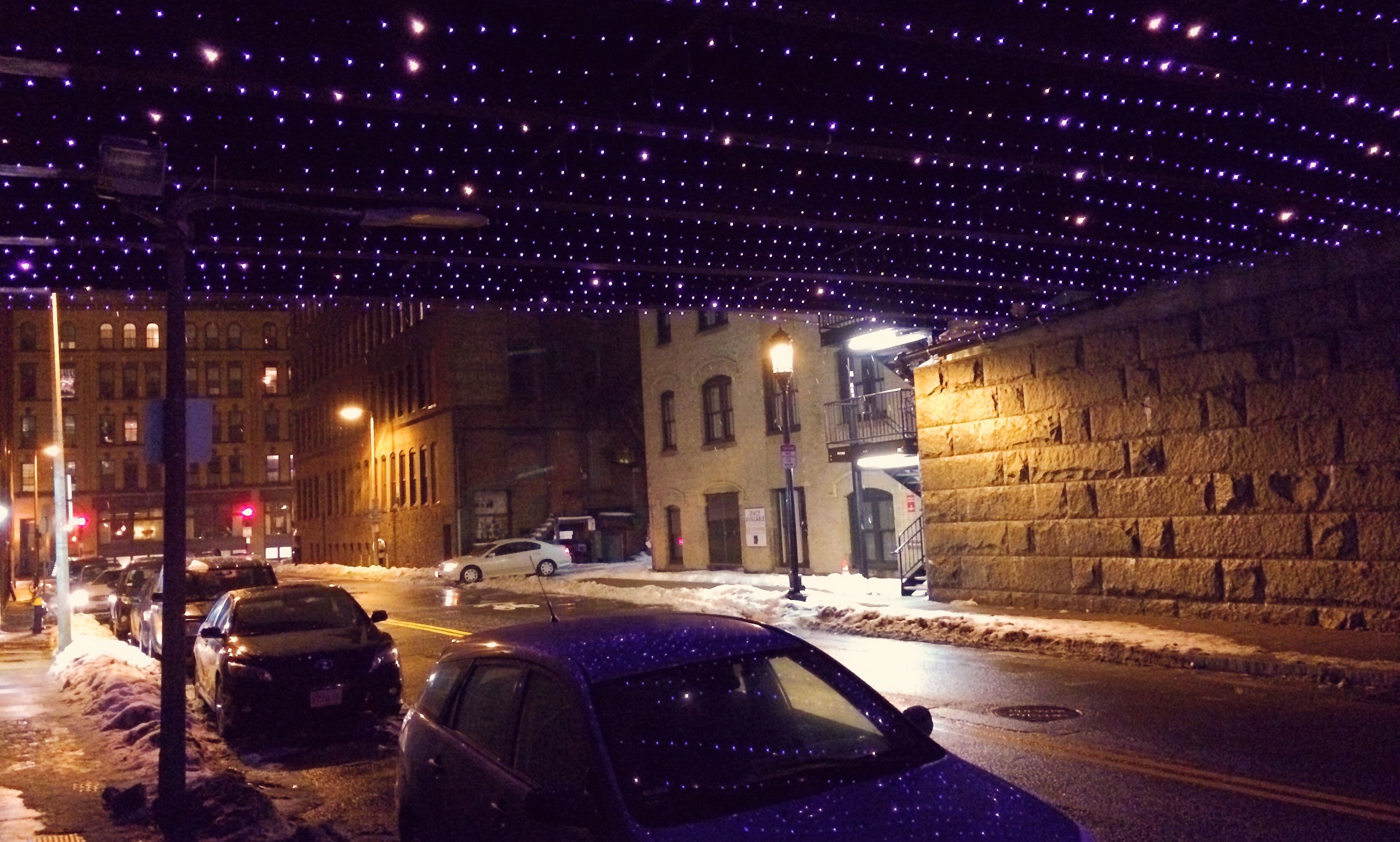 Seaport District in winter - purple holiday lights twinkling like stars below the underpass
