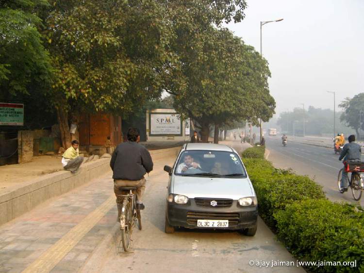 Car being drive in the cycle lane -- on the wrong side too