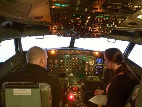 Me sitting in a flight simulator with a British Airways flight instructor.