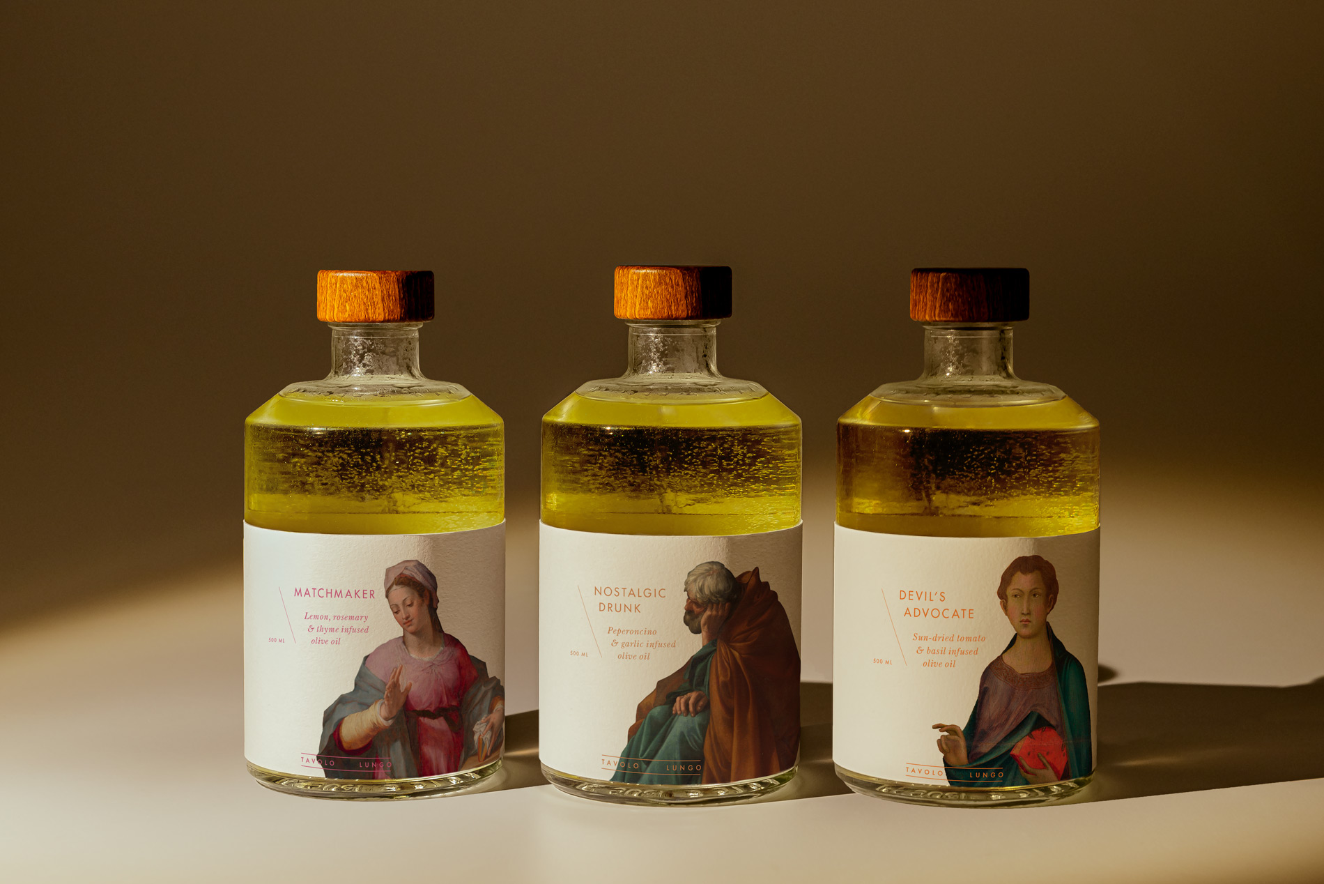 orange, ochre, and magenta ceramic olive oil bottles on a background of olive leaves