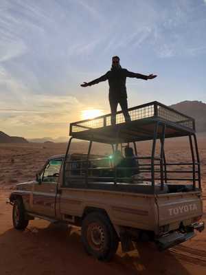 Dan Furze, on top of a Jeep, in the Wadi Rum desert, Jordan.