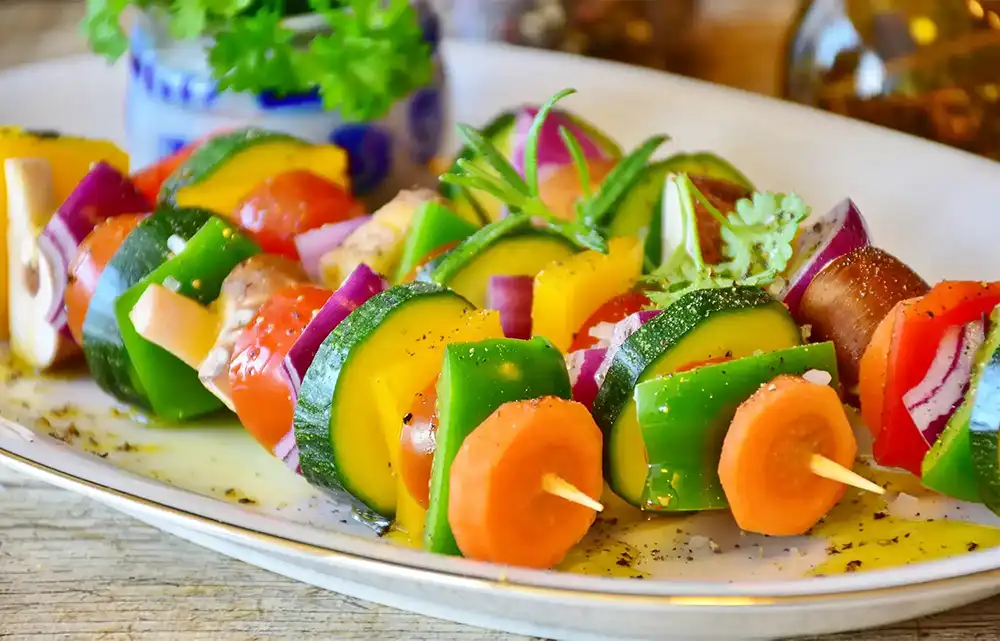 Healthly vibrantly colored meal of vegetable shish kabobs