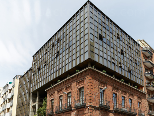 Red brick city building with exterior black metal window railings with modern extension structure on top Zoom background