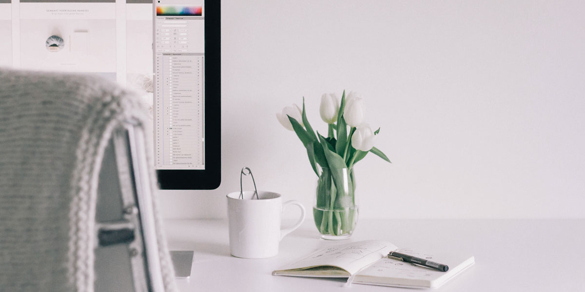 What qualifications do you need to become a UI designer? A vase of white tulips on a desk