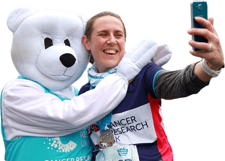 A runner taking a selfie with a polar bear mascot