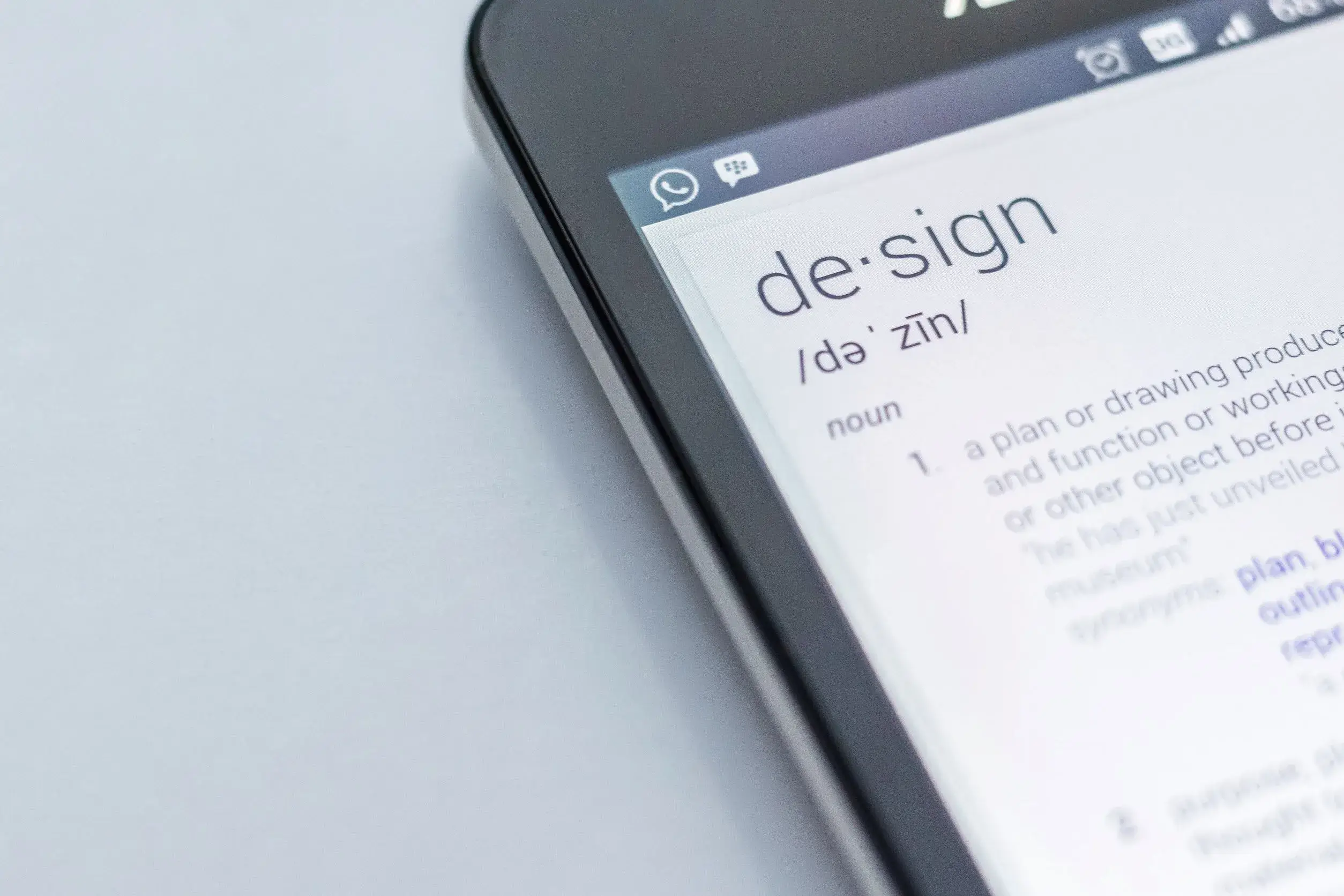 Mobile device displaying online dictionary definition of 'design' for aesthetic websites