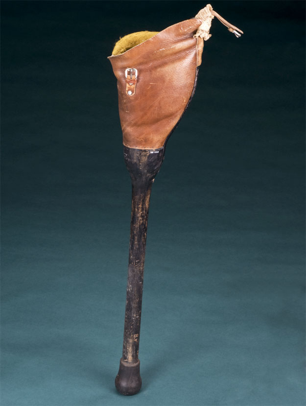 a simple DIY artificial leg circa 1940. A wooden stick-leg adjoins the body with a "leather knee-cap"