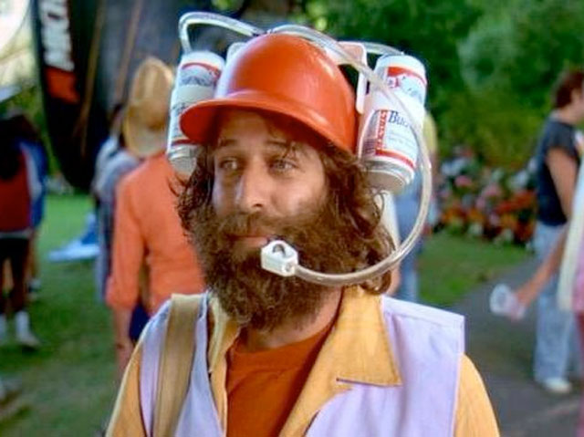 Happy Gilmore's caddy is drinking Budweiser from a two beer helmet