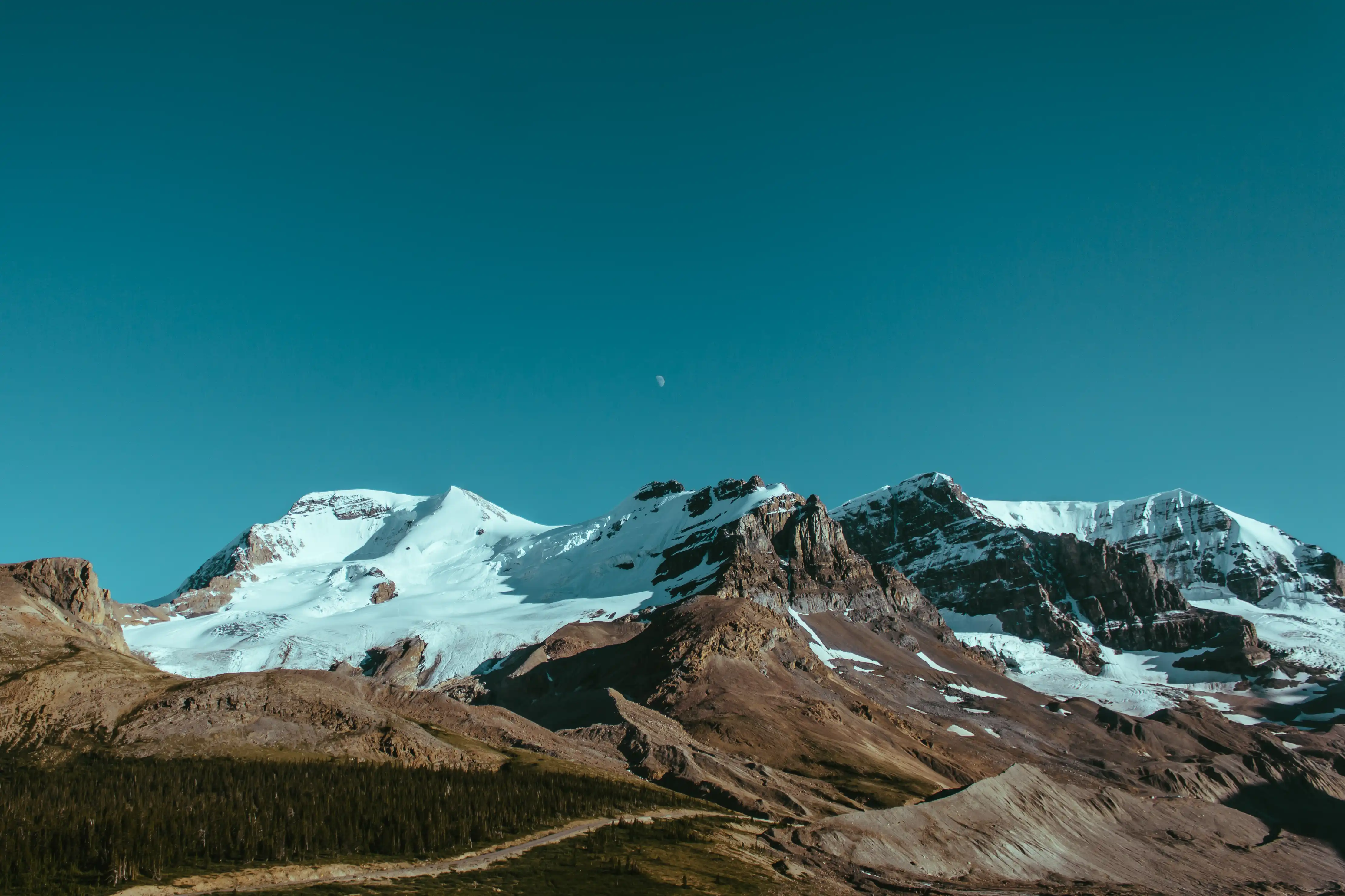 Alpine mountains under a clear sky by Ryan Schroeder