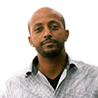 Portrait of an African man looking directly into the camera with a neutral facial expression.