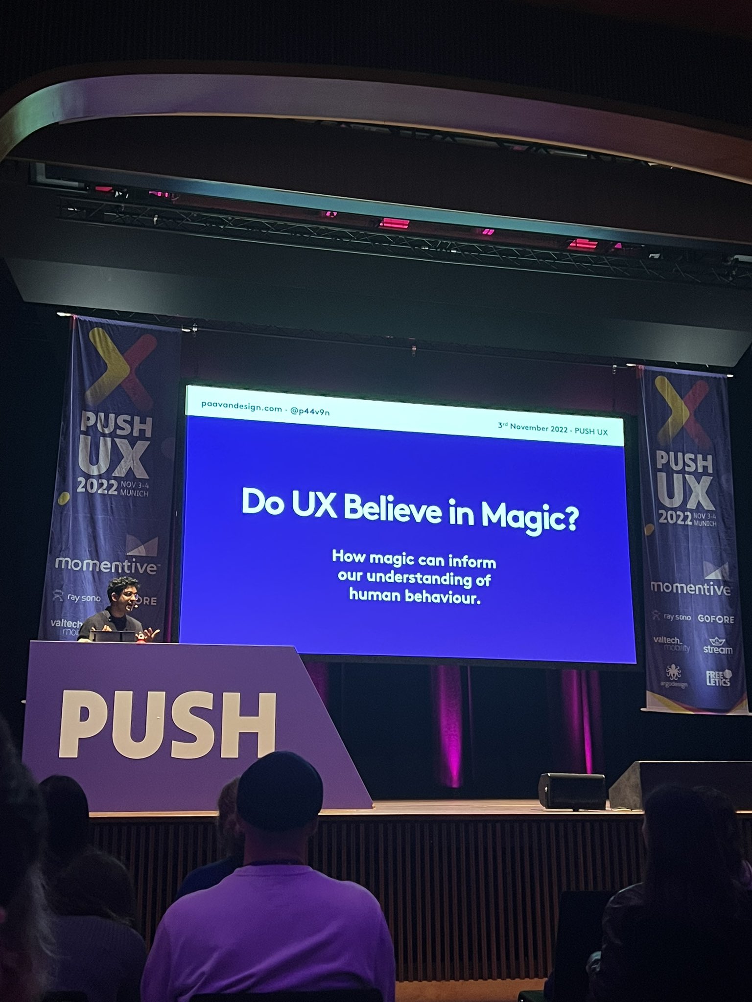 Photo of me on stage speaking at PUSH UX