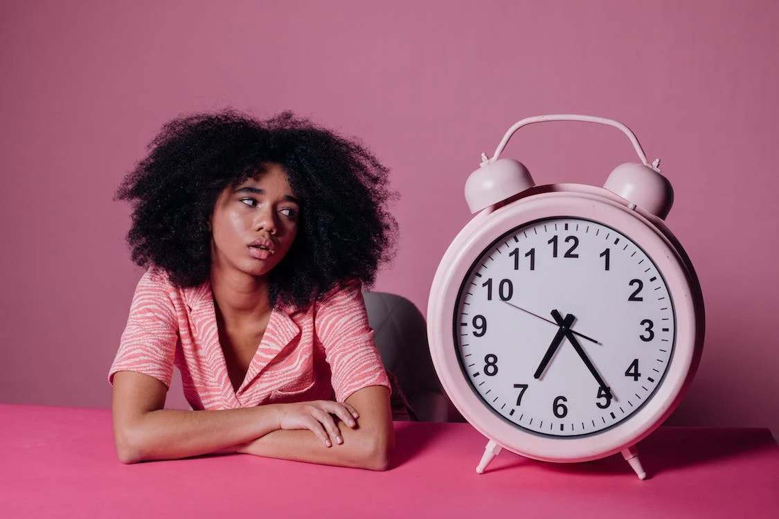 Woman with large alarm clock