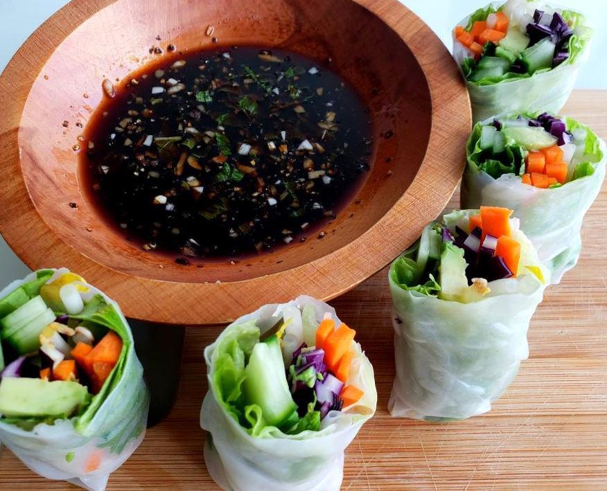 Six summer rolls around bowl of teriyaki dipping sauce
