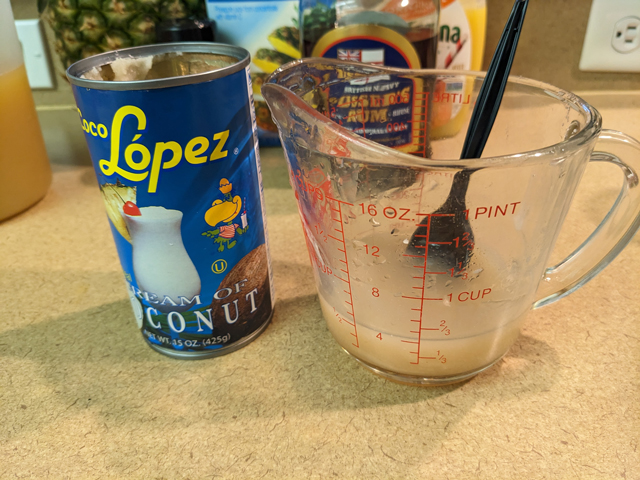 Making a Painkiller Step Four: Mixing in the Coco Lopez - aka - Cream of Coconut