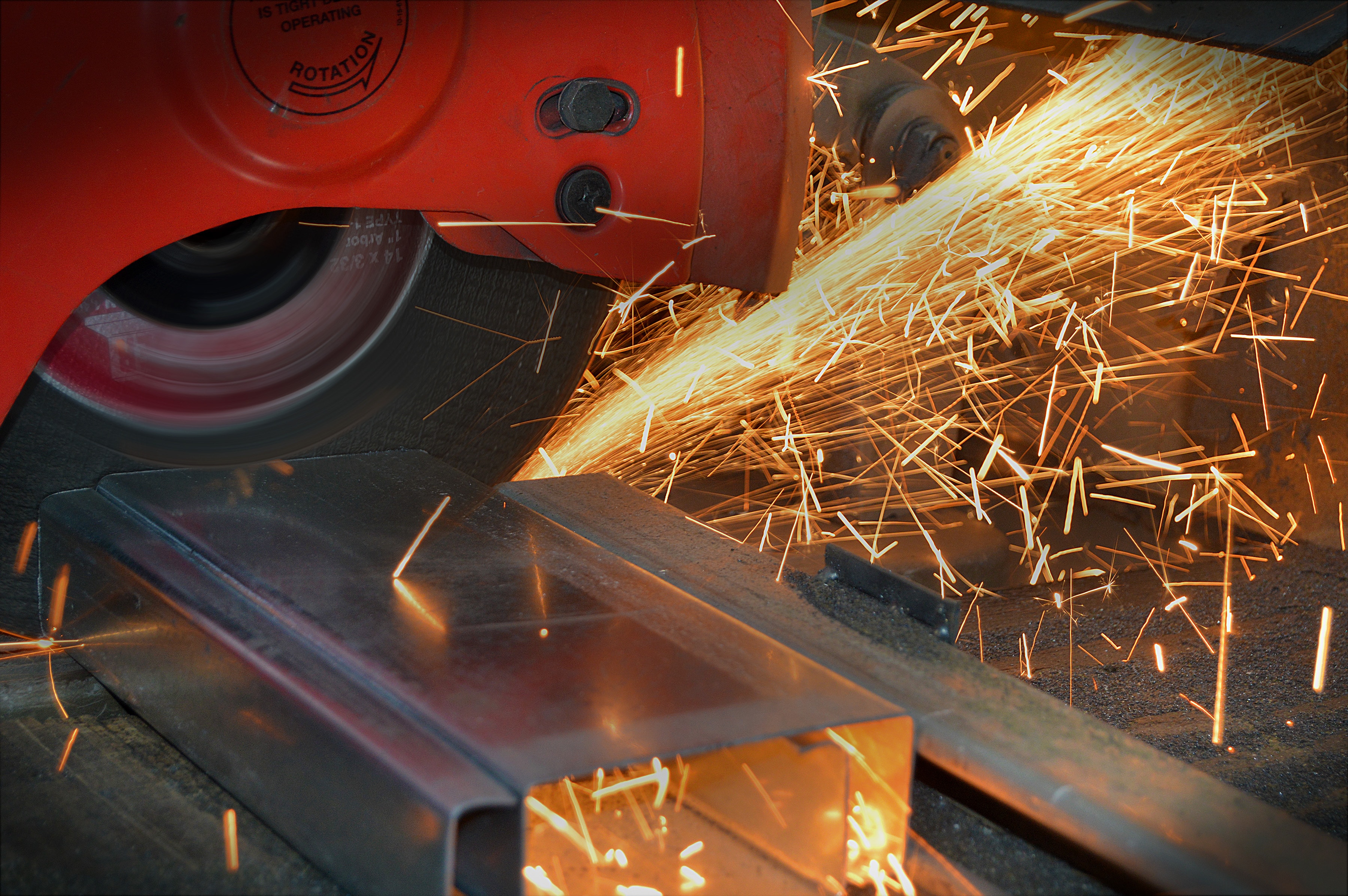 Photograph of a person cutting metal
