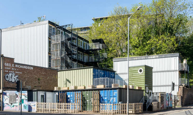 Containers stacked on top of each other with windows built into them