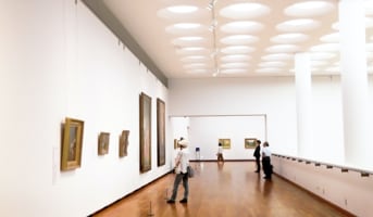 two people in museum looking at art