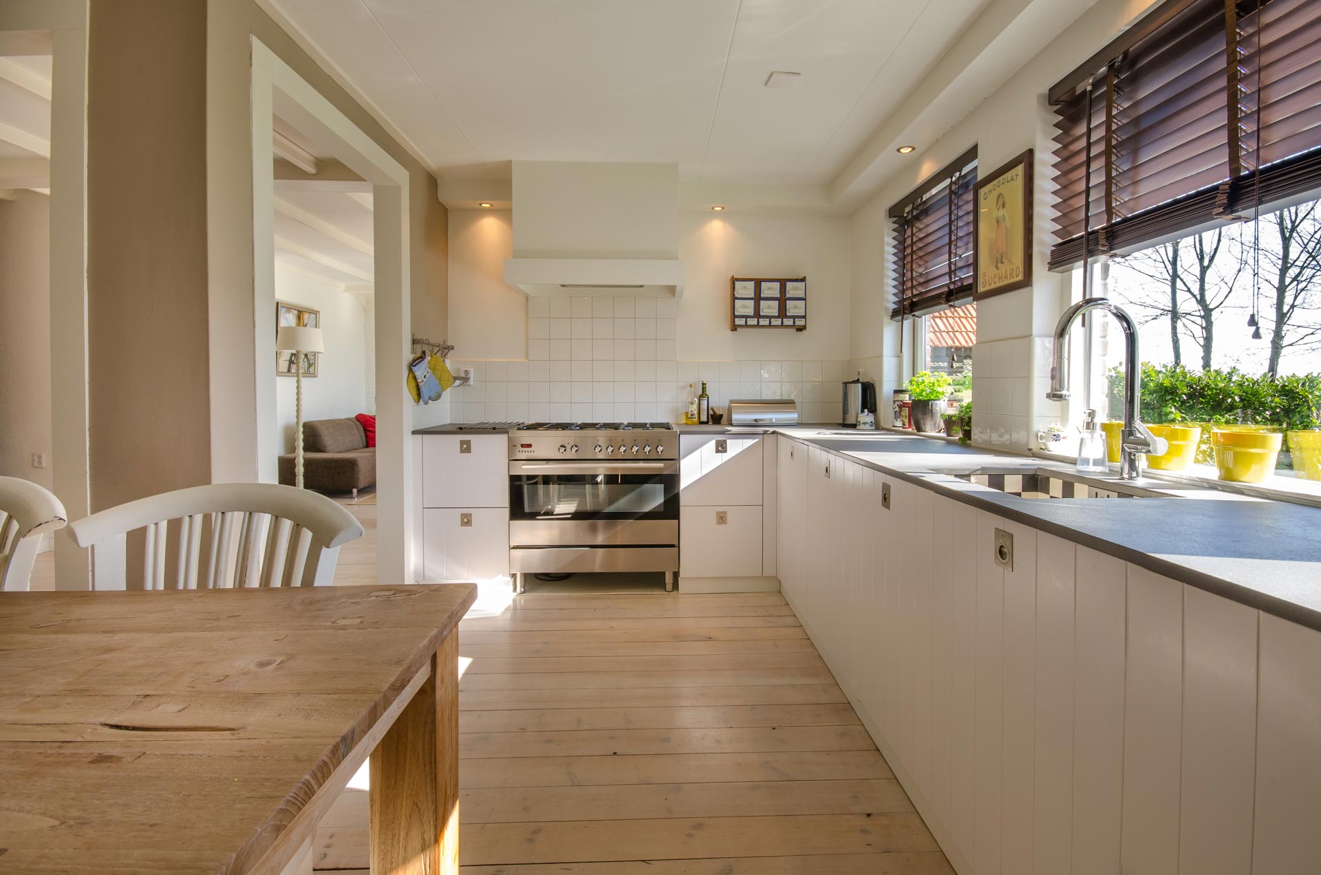 Immaculately clean kitchen with sunlight pouring in through open windows