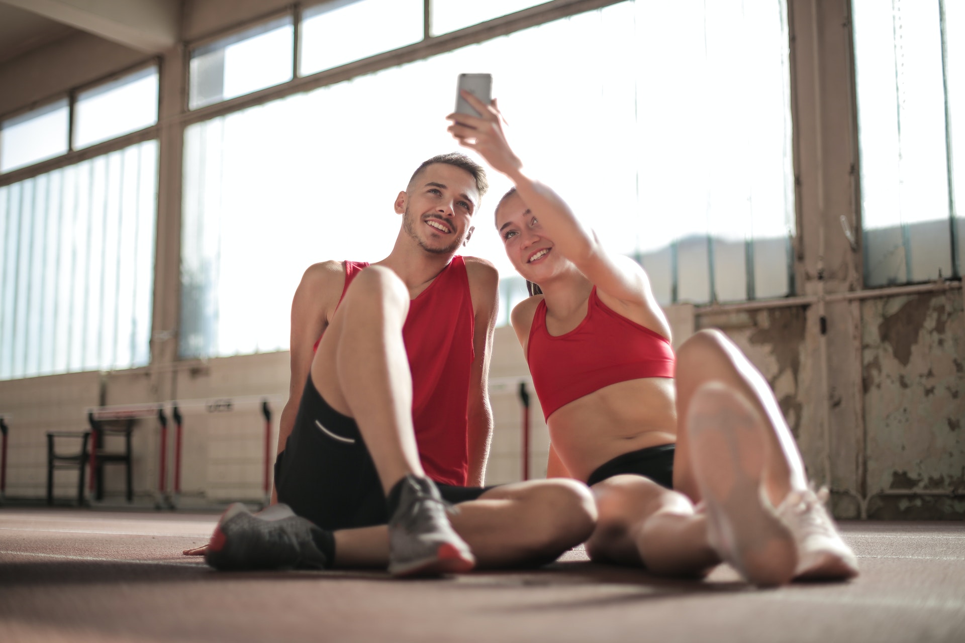 Couple smiling at phone and taking pictures