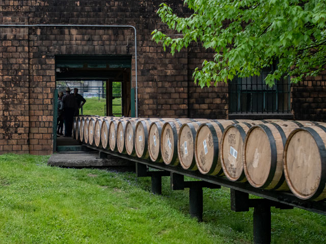 A row of beer barrels being moved into the brewery