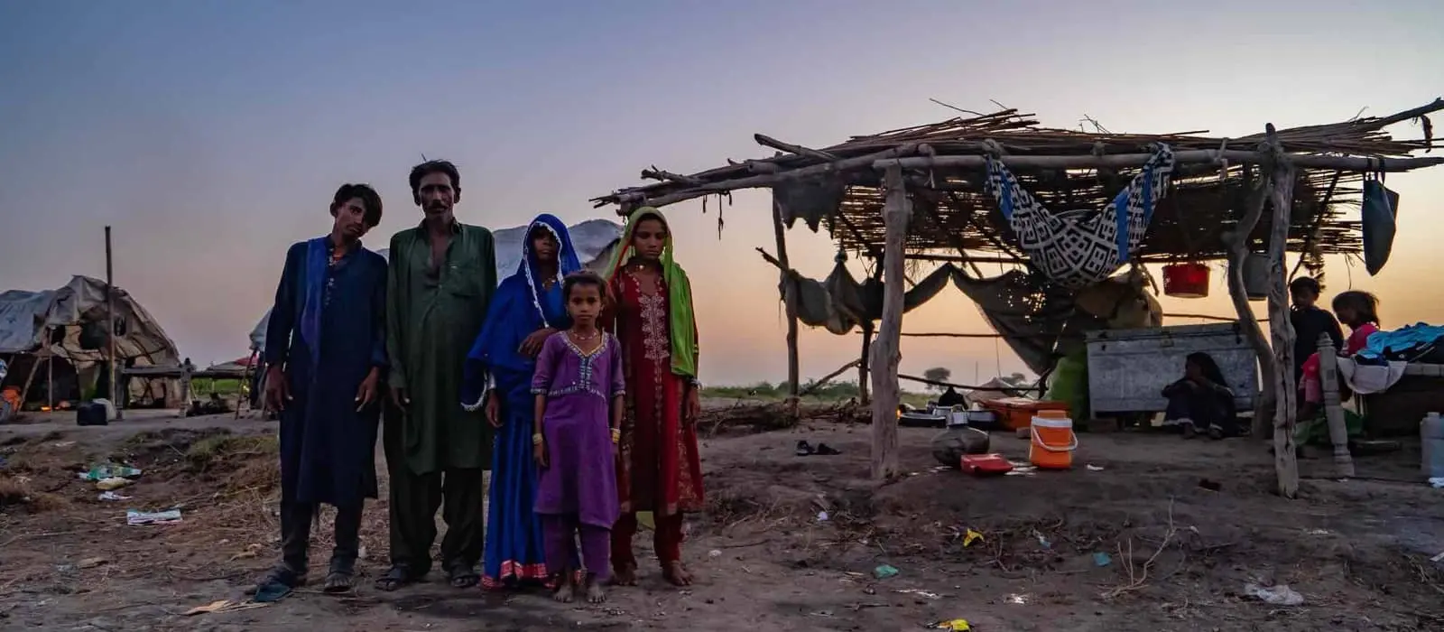 A Pakistani family outside their temporary shelter in Mirpur Khas district following the devastating floods of 2022