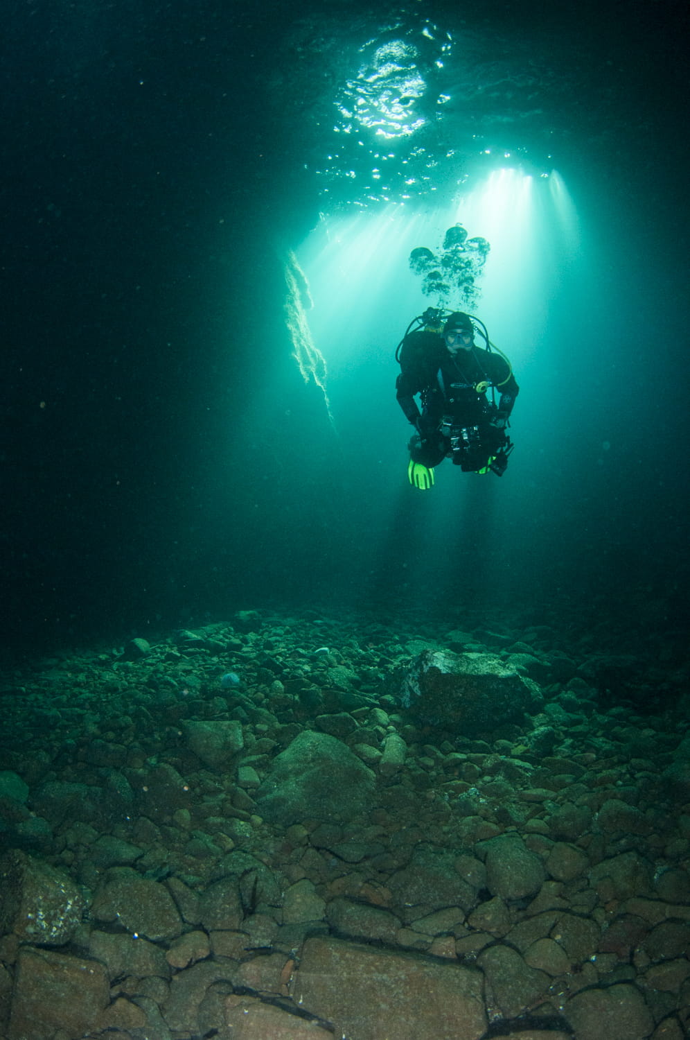 A diver exploring a sea cave