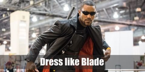 Blade has a 90's superhero touch to his iconic look. He wears a dark armor vest with black tactical pants, leather gloves and shoes, dark sunglasses, and a leather long coat.