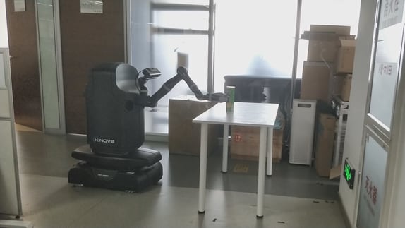 Kinova Movo is grasping an object on the table.