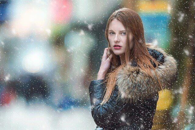 young woman in snowing background