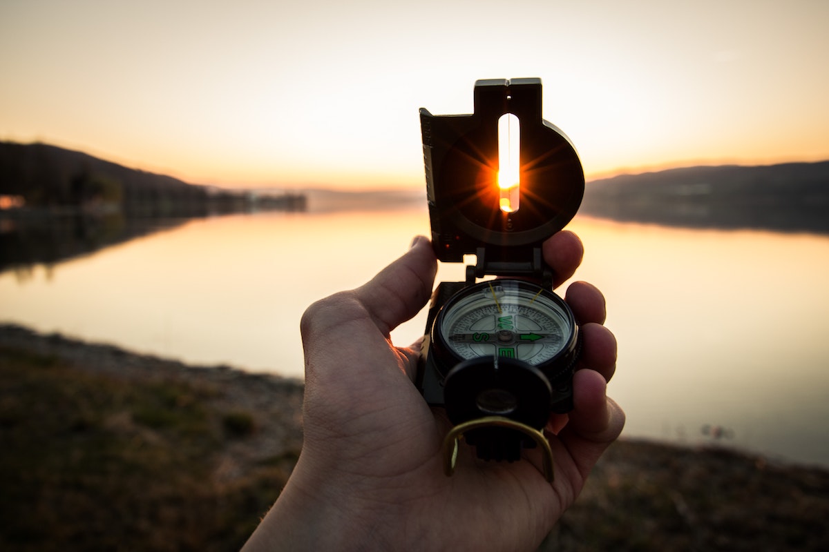 Guide with compass - Photo by Tim Graf on Unsplash