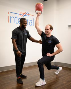 Basit, an Integral physiotherapist, working with Jared, a Kinesiologist at Integral Physiotherapy