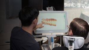 Dr Alfred Wo showing a patient at Glenbrook Dental an image of teeth on his computer screen