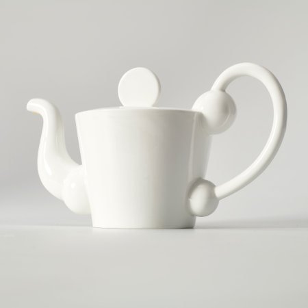 White teapot with spherical shapes incorporated into the spout and the handle, and a disk-shaped lid.