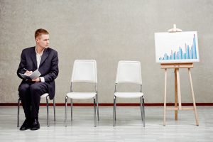 Business man sitting near a graph showing trends for search engine optimization and digital marketing in Austin