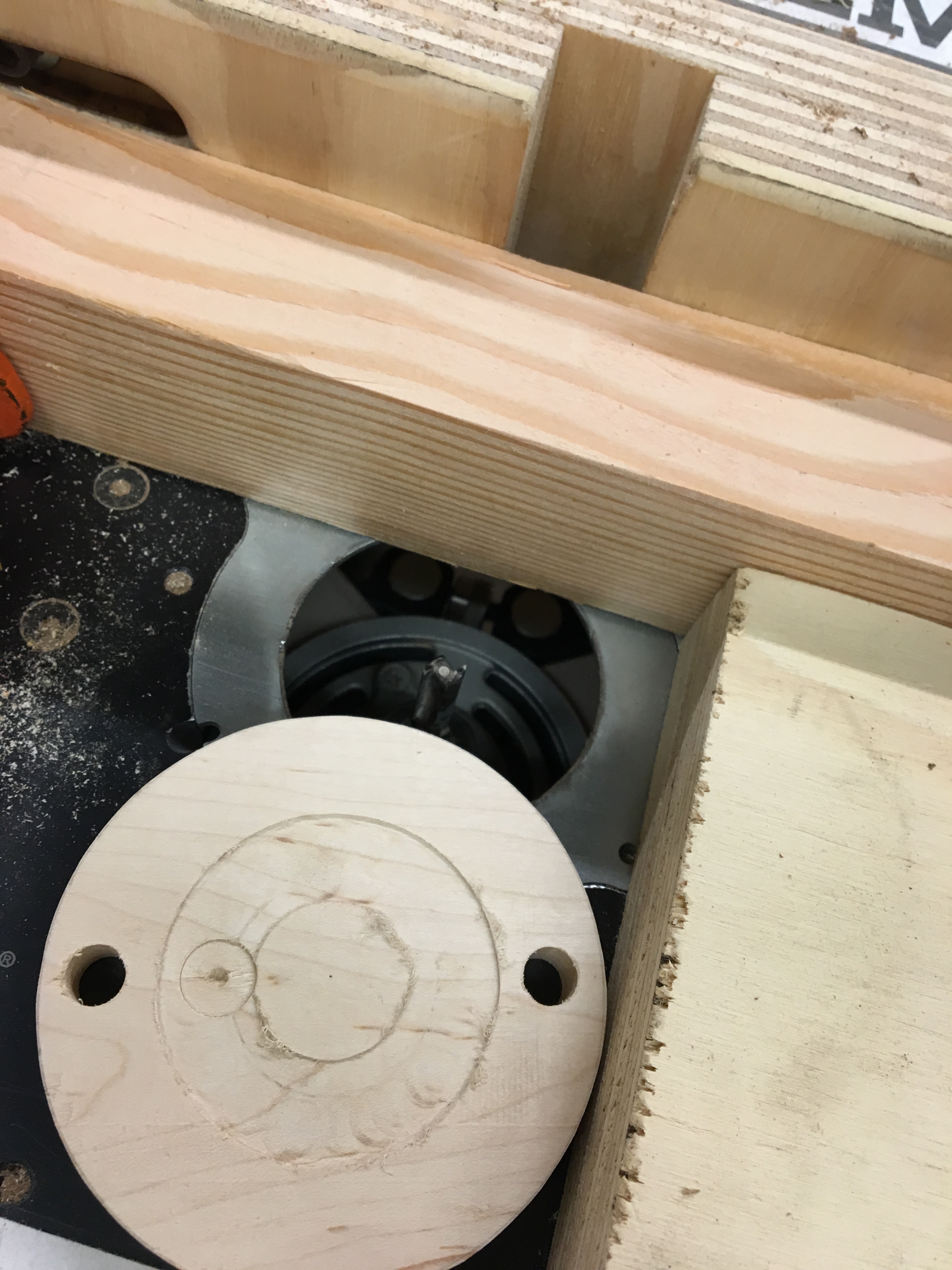 Using a table router to carve out a pocket in the stand cap